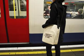 Photo: person wearing black and holding a tote bag...