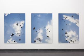 Three photographs of a blue sky with white clouds....