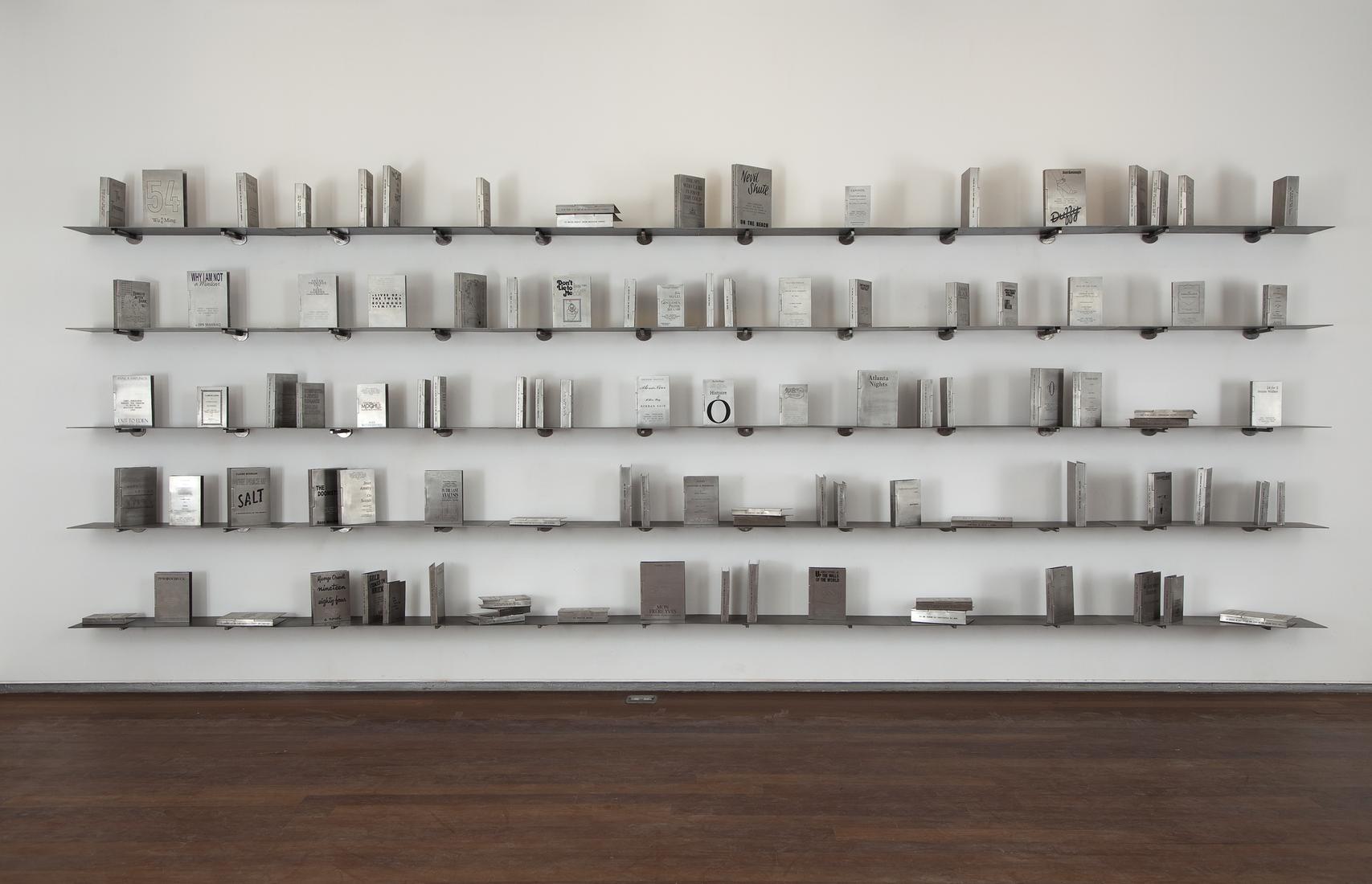 Books with engraved metal covers on five metal flo...