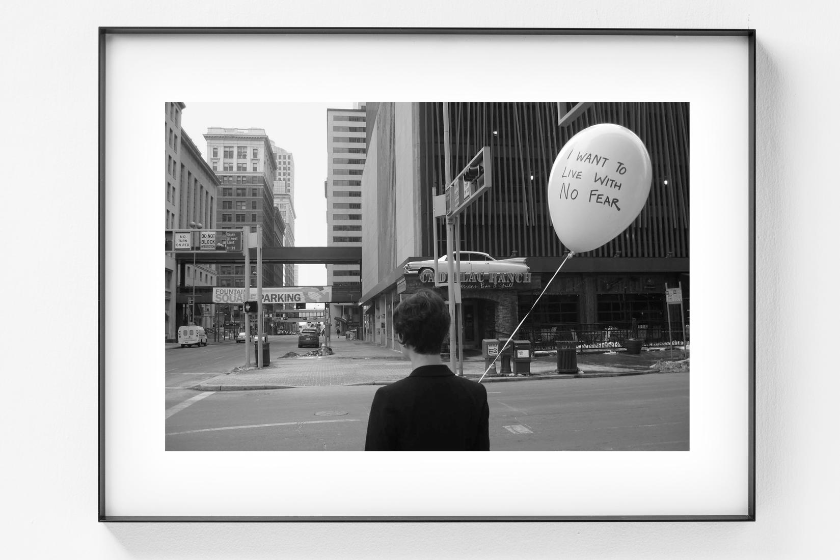 Framed black and white photo of a person, with the...