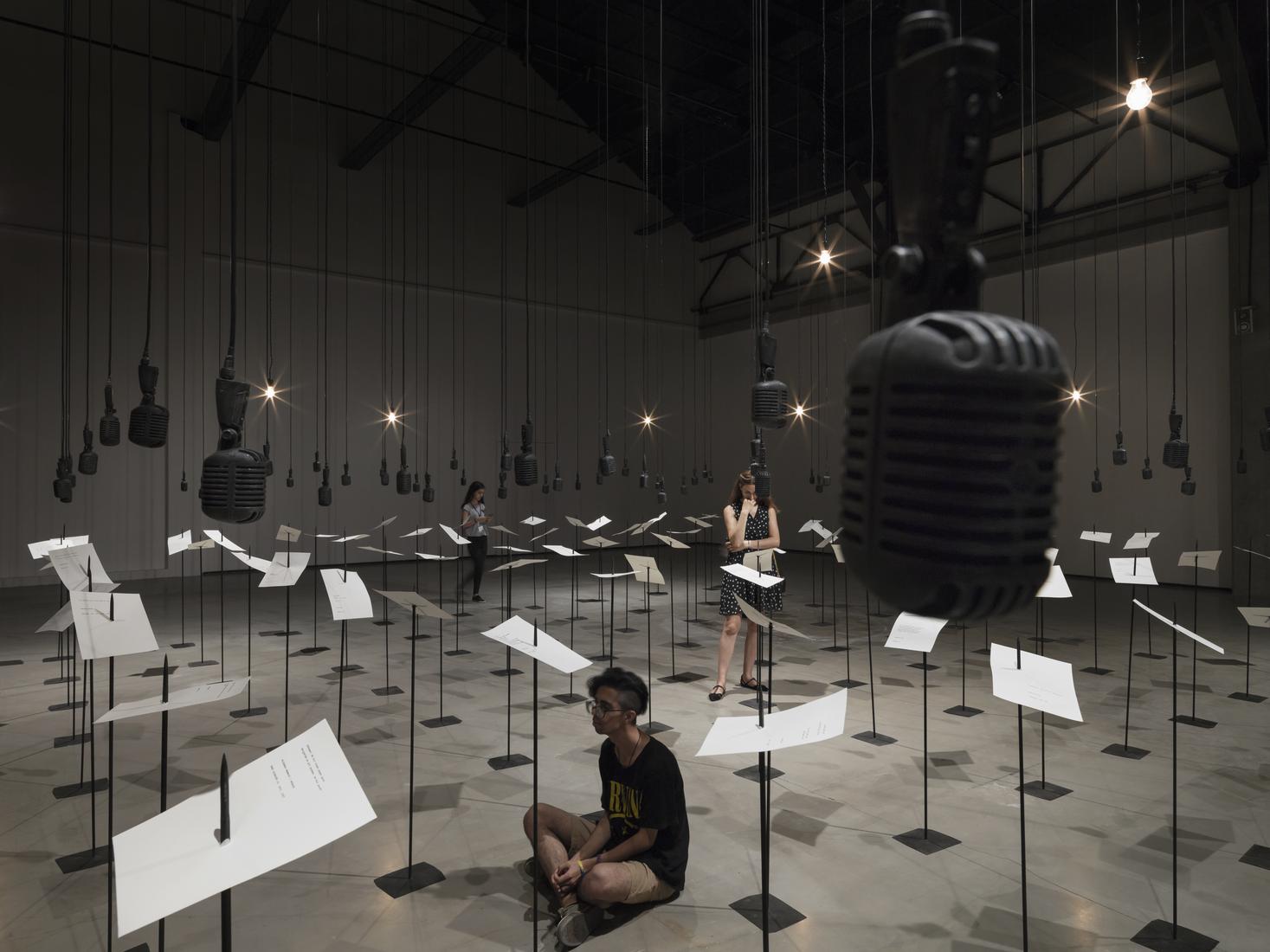 Photo of room filled with a grid of pieces of pape...