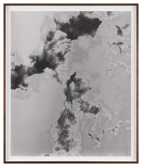 Lisa Oppenheim Man holding large camera photograph...